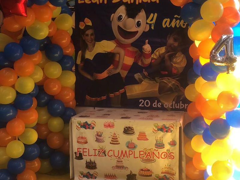 Fondo decorado con arco de globos azul, naranja y amarillo para cumpleaños infantil